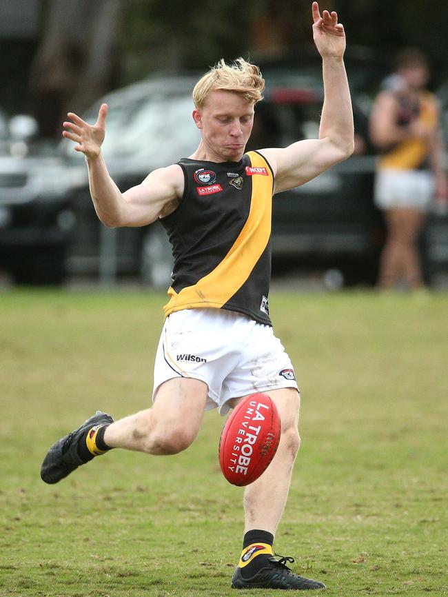 NFL: Max Jones gets a kick for Heidelberg. Picture: Hamish Blair