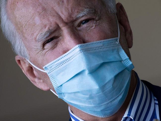 Democratic presidential candidate former US Vice President Joe Biden wears a facemask as he speaks to reporters at Phoenix Sky Harbor Airport, October 8, 2020, in Phoenix, Arizona. (Photo by Brendan Smialowski / AFP)