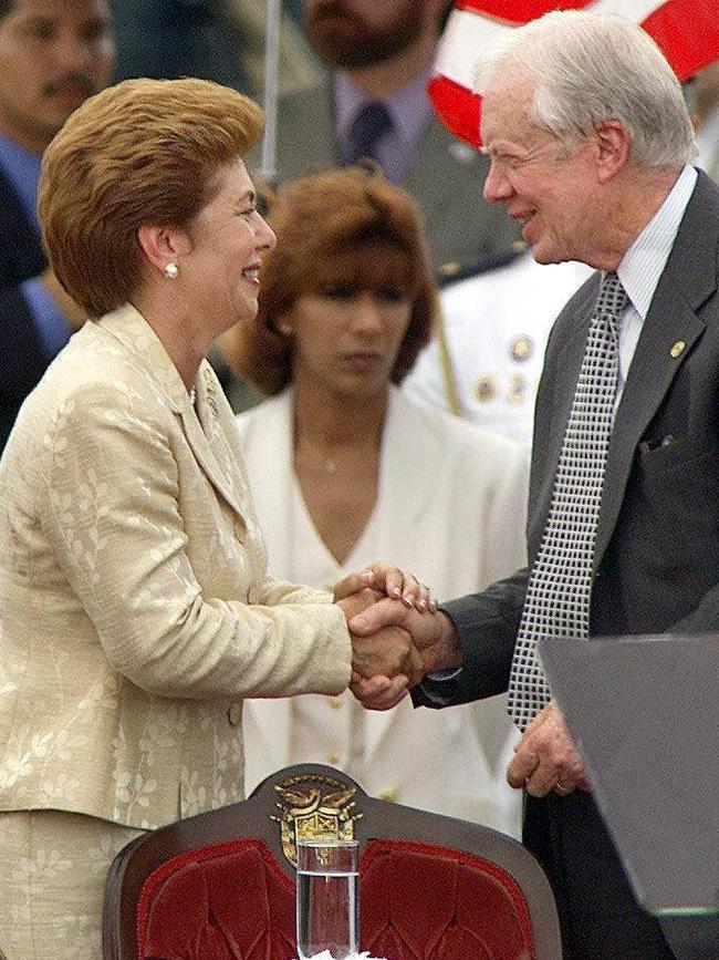 Then US President Jimmy Carter shakes hands with Panamanian President Mireya Moscoso after handover of the Panama Canal to Panama, on 14 December 1999. Picture: AFP