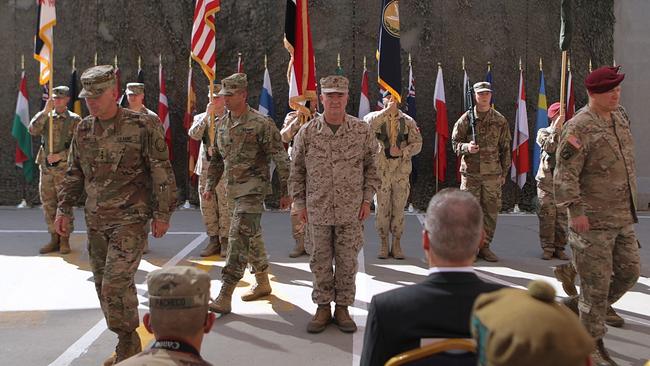 US Army Lt. General Pat White, III Armored Corps Commanding General, second left, and Commanding General for U.S. Central Command Gen. Kenneth F. McKenzie Jr. centre, take part in a transfer of authority ceremony at Union III, base in Baghdad, Iraq.