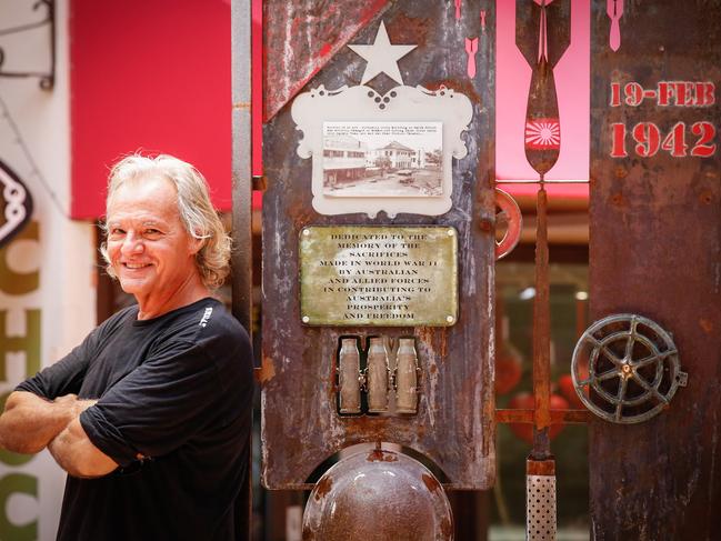 Darwin artist Wayne Miles with his WWII-inspired artwork in the Star Village. Picture: Glenn Campbell