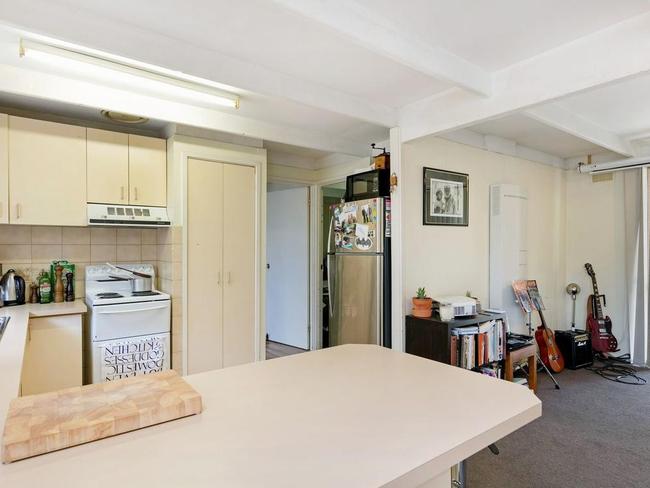 The kitchen leads to a third bedroom at the back of the home.