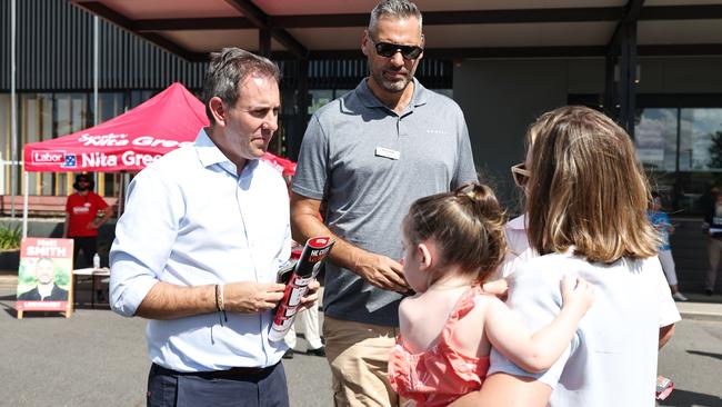 Treasurer Jim Chalmers joins Labor candidate for Leichhardt Matt Smith to hand out how to vote cards for the federal election to a Far North Queensloand voter and her daughter (name withheld) at the Smithfield.. Picture: Brendan Radke