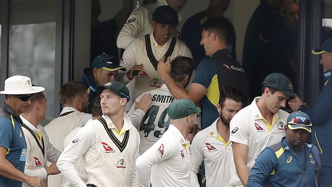 Smith’s teammates congratulate him on his return to the pavilion. Picture: Getty Images
