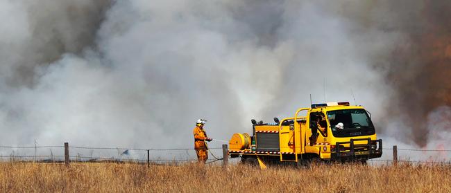 Firefighters battle in the Gold Coast hinterland yesterday. Picture: Nigel Hallett