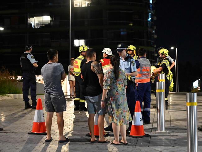 Police check the unit numbers of residents. Picture: AFP