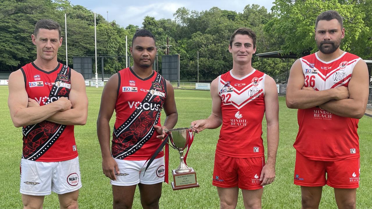 Tiwi Bombers players Sam Darley and Stanley Tipiloura opposite Waratah players Scott Carlin and Arnold Kirby holding the Maurice Rioli Cup ahead of their Round 12 2023-24 NTFL fixture. Picture: Nathaniel Chambers