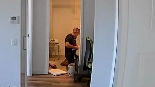 He was also filmed allegedly using a rolling pin in the woman's bathroom. Picture: Channel 9 / Nine News