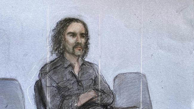 This court artist drawing by Elizabeth Cook shows Russell Brand appearing in the dock on Friday. Picture: Elizabeth Cook/PA via AP