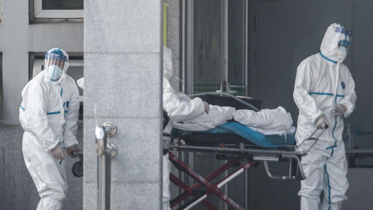 Medical staff members carry a patient into the Jinyintan hospital, where patients infected by a mysterious SARS-like coronavirus are being treated in Wuhan. Picture: STR/AFP