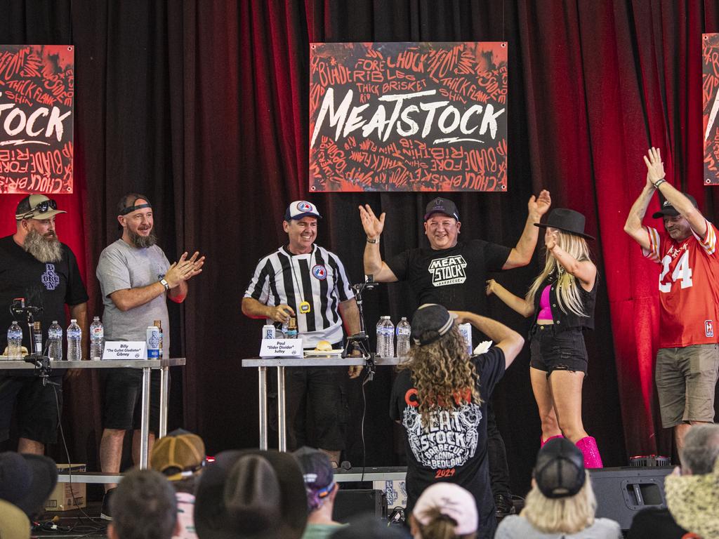 Paul Sulley (centre) celebrates his win in the Phat Boyz Slider Throwdown eating competition at Meatstock at Toowoomba Showgrounds, Sunday, March 10, 2024. Picture: Kevin Farmer