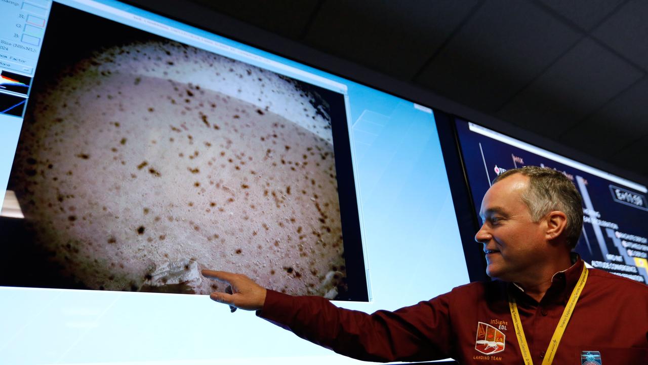 NASA engineer and InSight project manager Tom Hoffmamnon points to the first image upon a successful landing by the InSight spacecraft. Picture: AP