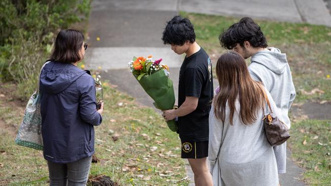 Friends lay flowers at the scene of of the car accident.