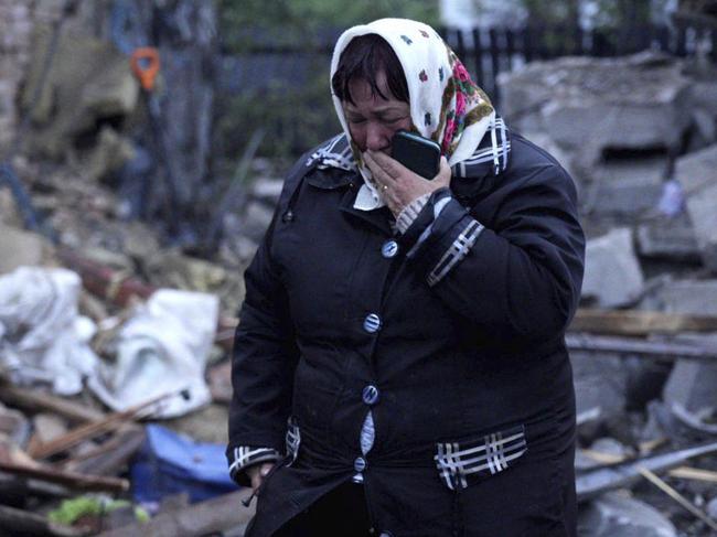 In this photo provided by the Ukrainian Emergency Service, a local resident cries standing amid the rubble of her house ruined after Russia's air attack in Khmelnytskyi region, Ukraine on May 25. Picture: Ukrainian Emergency Service via AP