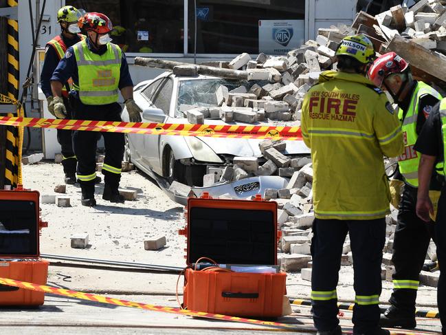 Emergency service crews at the scene where a wall collapsed on New Canterbury Road in Hurlstone Park in Sydney, Monday, February 24, 2020. (AAP Image/Joel Carrett) NO ARCHIVING