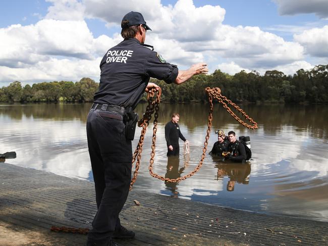 Police divers search and recover a vehicle off Floyd Bay boat ramp on the Georges River yesterday. Picture: Dylan Robinson