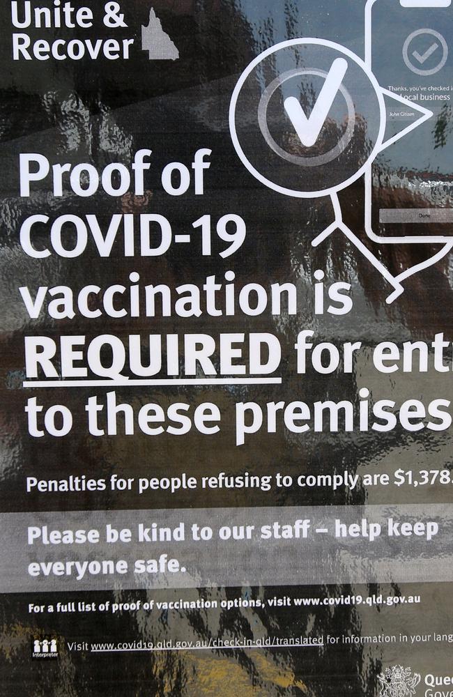 A sign urging customers to show proof of vaccination. Picture: Steve Pohlner