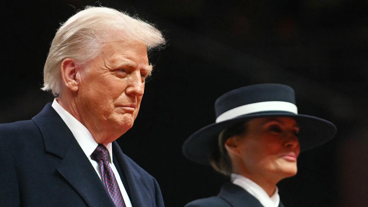 US President Donald Trump and First Lady Melania Trump watch bands perform during the inaugural parade inside Capital One Arena, in Washington, DC, on January 20, 2025. (Photo by Jim WATSON / AFP)