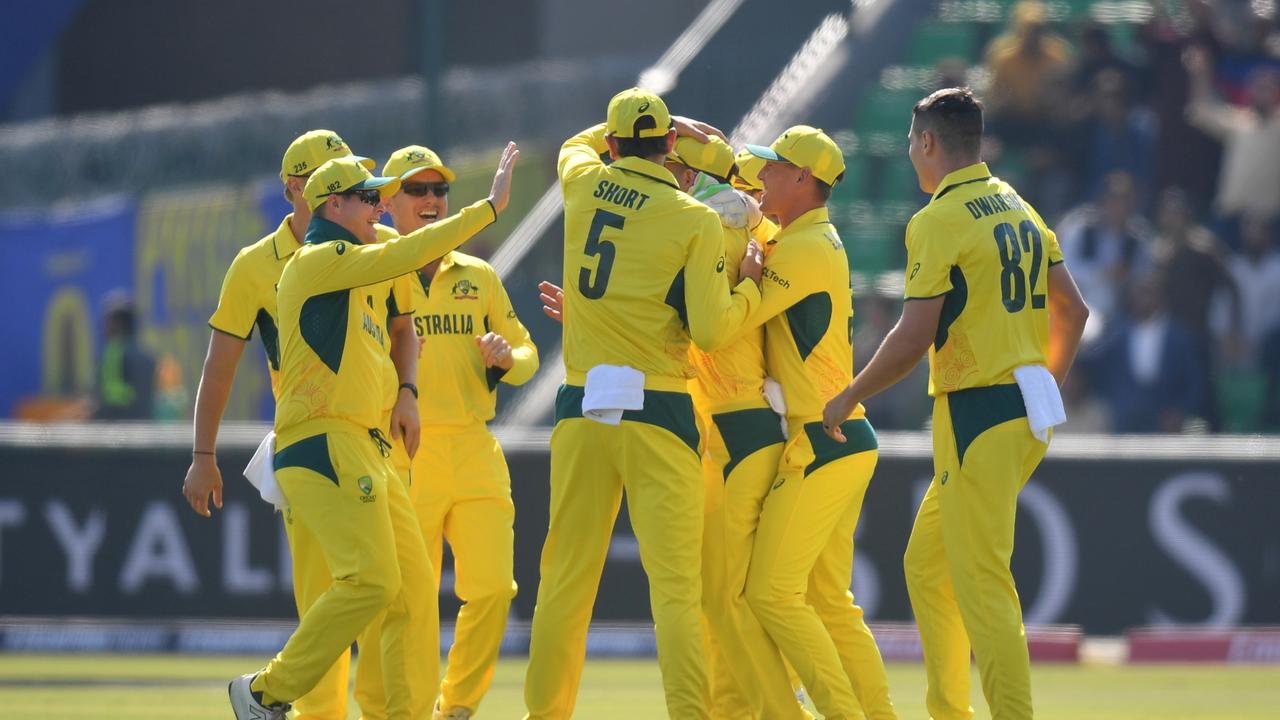 The Aussies celebrate the early wicket. (Photo by Sameer Ali/Getty Images)