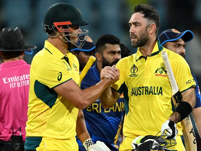 Australia's Marcus Stoinis (L) and Glenn Maxwell celebrate their victory at the end of the 2023 ICC Men's Cricket World Cup one-day international (ODI) match between Australia and Sri Lanka at the Ekana Cricket Stadium in Lucknow on October 16, 2023. (Photo by TAUSEEF MUSTAFA / AFP) / -- IMAGE RESTRICTED TO EDITORIAL USE - STRICTLY NO COMMERCIAL USE --