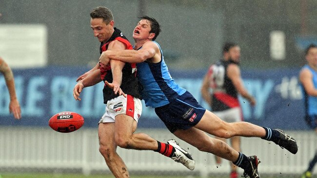 Sam Jonas lays a big tackle on West Adelaide skipper Chris Schmidt for Sturt. Picture: Tom Huntley