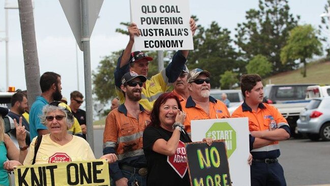 Counter protesters hold green #StartAdani and pro-coal placards during a protest against the company’s Carmichael mine.