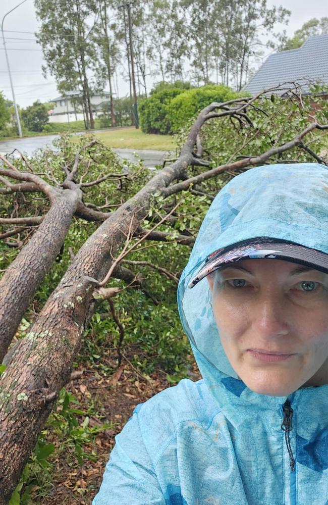 Jenny Devaus of Springwood with a giant tree in her front yard after Cyclone Alfred. Picture: Jenny Devaus