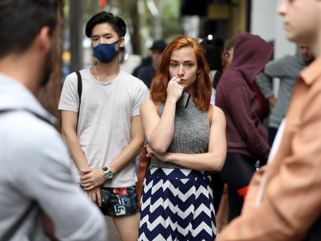 23/03/2020.Newly unemployed due to the C-19 fallout, (L-R) Chef Albert Ruan (27) and Retail assistant Celeste Mather (21) wait anxiously in a large queue outside Darlinghurst Centrelink due to mass confusion of information on welfare payments. Jane Dempster/The Australian.