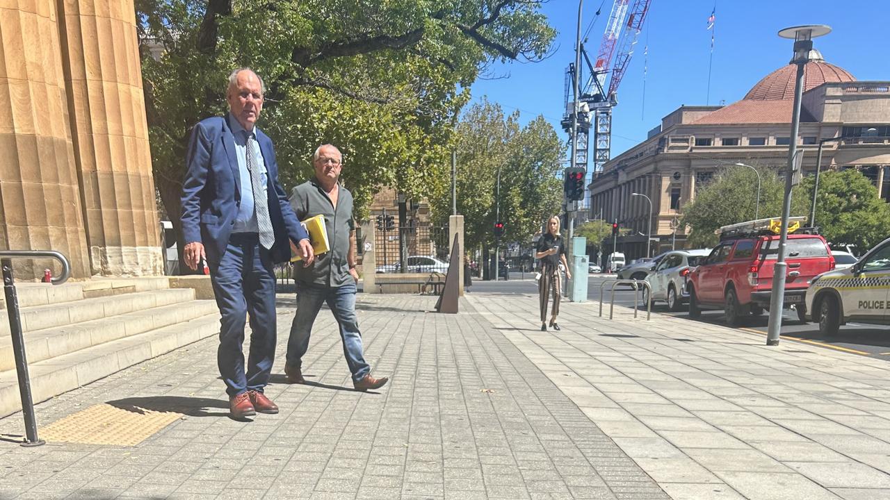 Athelstone dog owner Yuri Lediaev, right, leaves the Adelaide Magistrates Court with his lawyer on Tuesday.