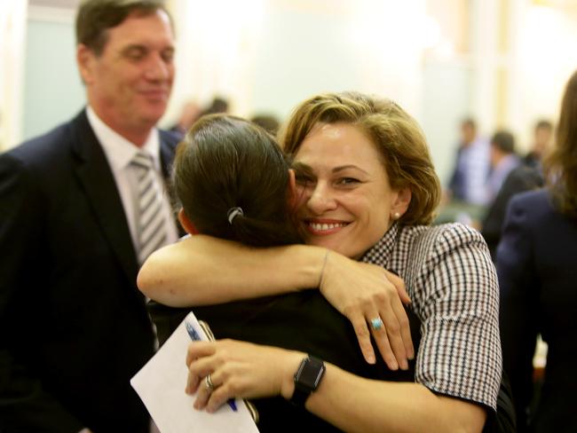 Deputy Premier Jackie Trad, who spearheaded the legislation, embraces another MP after the vote. Picture: Steve Pohlner/AAP