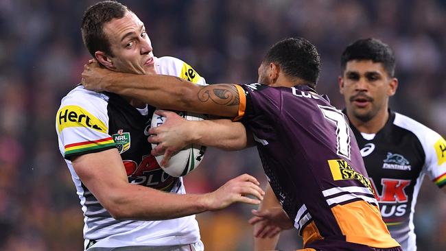 Panthers forward Isaah Yeo is tackled by Broncos halfback Benji Marshall.