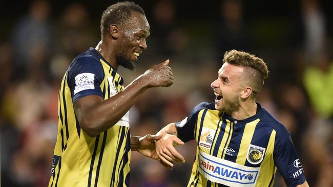 Usain Bolt celebrates his second goal with Mariners teammate Jordan Murray. Picture: AFP