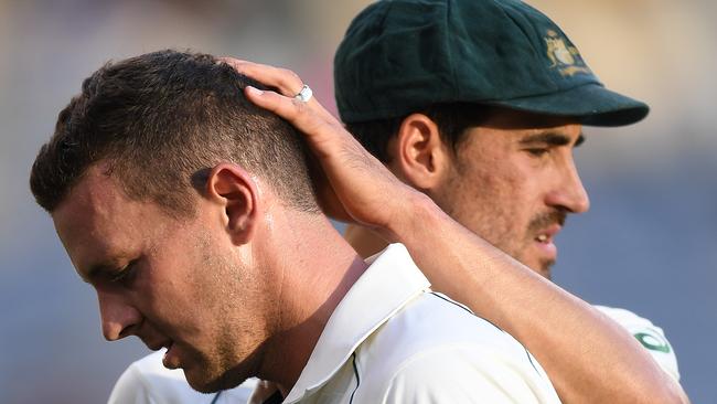 Josh Hazlewood is consoled by Mitchell Starc as he leaves the field after sustaining an injury on day two of the first Test in Perth. Picture: AAP