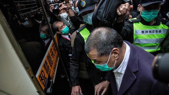 Media tycoon Jimmy Lai (C) is escorted onto a prison van outside the Court of Final Appeal in Hong Kong on December 31, 2020, after he was ordered back to jail as the city's highest court granted prosecutors an appeal against his bail. Picture: AFP