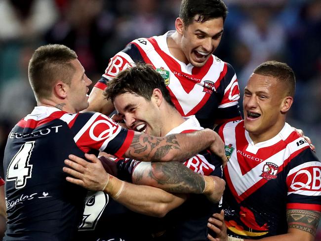 Roosters Aiden Guerra celebrates scoring a try with his team mates during the round 24 NRL game between the Sydney Roosters and the St George Illawarra Dragons at Allianz Stadium . Picture : Gregg Porteous