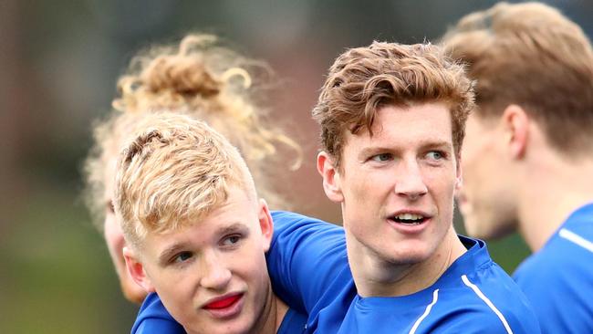 Red Og Murphy and Lachlan Hosie look on during a North Melbourne Kangaroos training session at Arden Street Oval, North Melbourne, Wednesday, August 7, 2019. (AAP Image/Scott Barbour) NO ARCHIVING