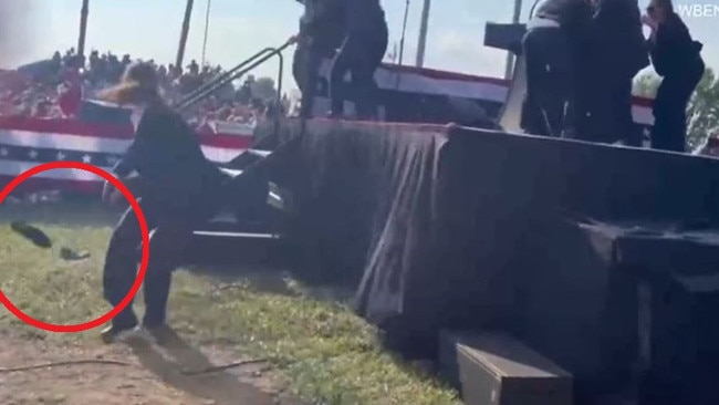 One of Mr Trump's shoes goes flying off the stage. You can see Secret Service agents surrounding him in the top right.