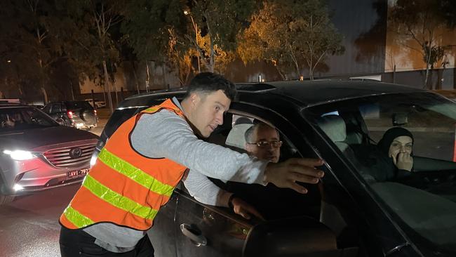 Greater Shepparton mayor Shane Sali directs a driver to collect sandbags. Picture: Kiel Egging