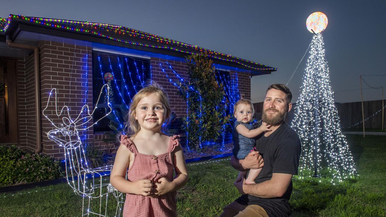 (from left) Ivy, Remi and Aiden Ferguson outside their home's Christmas display in Milford St Westbrook. Friday, December 3, 2021. Picture: Nev Madsen.