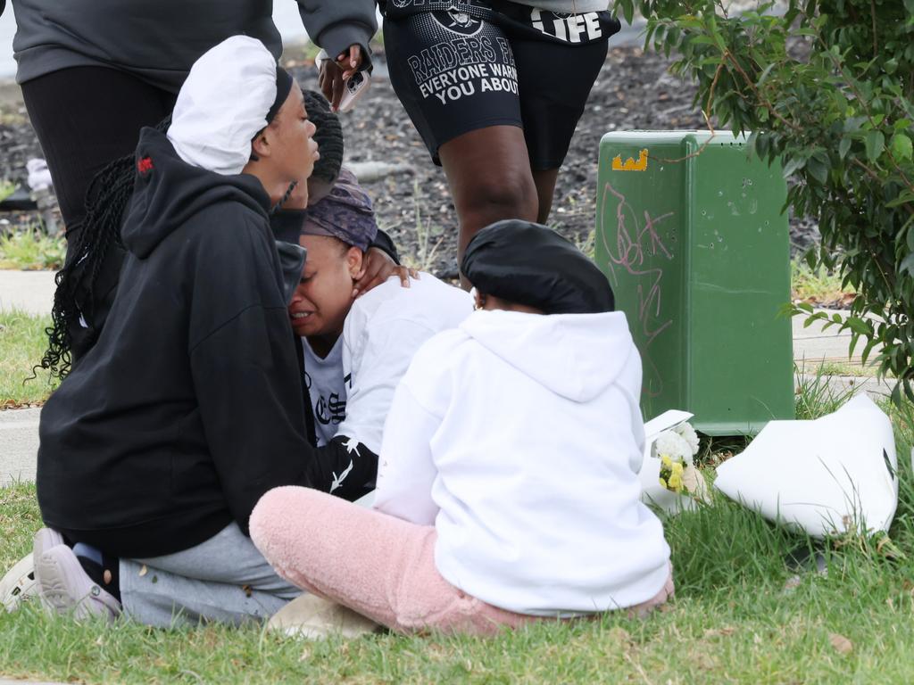 Family and friends gather at the scene of the crime on Thursday. Picture: David Crosling