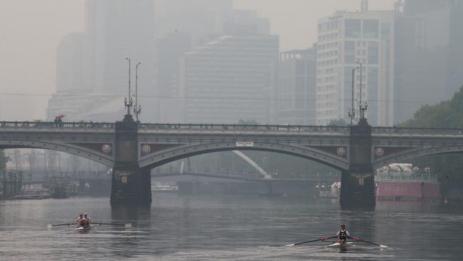 Bushfire smoke haze and light rain hang over the Melbourne CBD. Picture: David Crosling