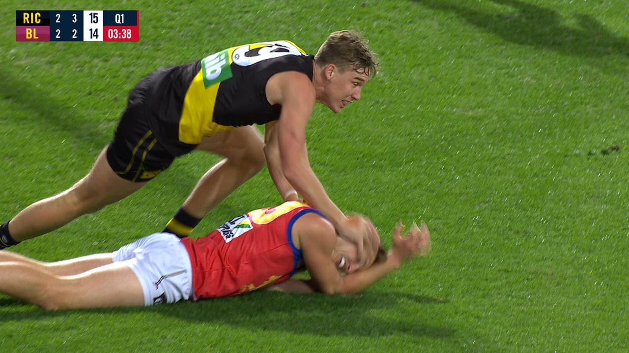 Richmond's Tom Lynch drives the head of Brisbane's Alex Witherden into the ground.