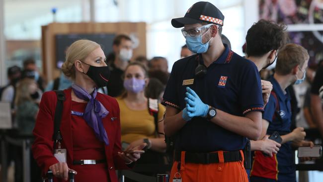 Passengers and Crew arrive at Adelaide Airport and proceed to the COVID-19 processing station after embarking from a delayed 12.40pm Brisbane Virgin Flight VA1388. Picture: NCA NewsWire / Emma Brasier