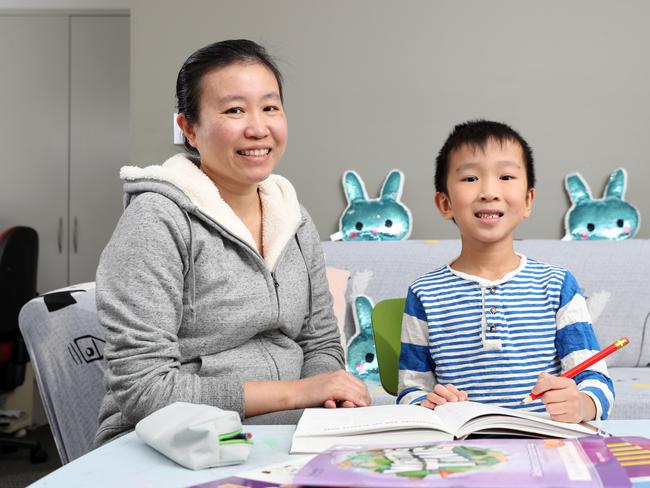 Iris Ni doing school work with her year 2 son Braydon, 7, at home in St Ives. Picture: Jonathan Ng