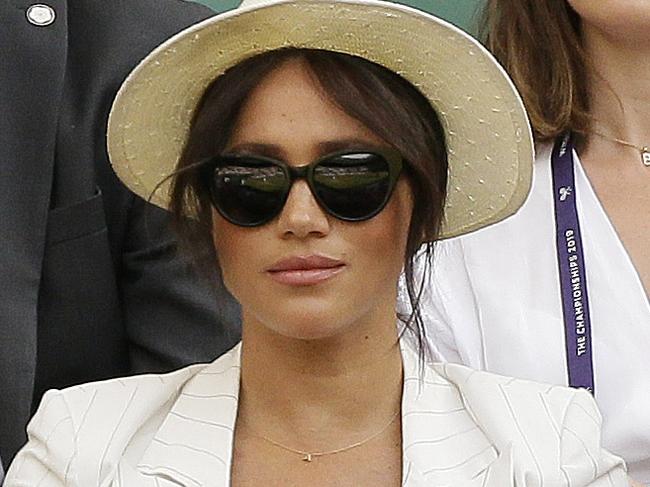 Meghan, Duchess of Sussex, center, on Court Number One to watch United States' Serena Williams play Slovenia's Kaja Juvan in a singles match during day four of the Wimbledon Tennis Championships in London, Thursday, July 4, 2019. (AP Photo/Tim Ireland)