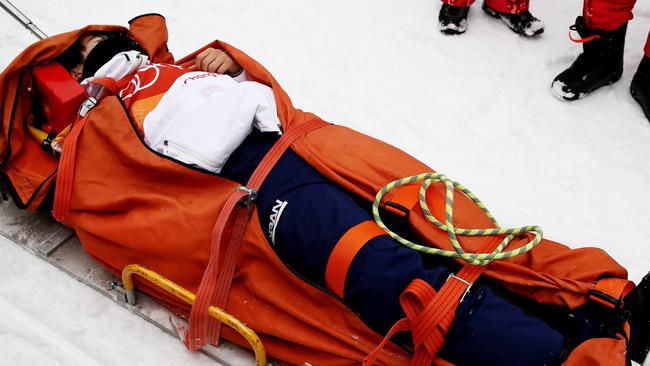 Yuto Totsuka being taken off the course following a crash in the half-pipe final.