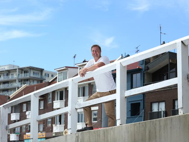 13/01/2022. Warren Livesey, who has started a company that buys and sells airspace above residential apartments. It is the new frontier in real estate. Pictured in front of apartment buildings in Bronte beach in Sydney's eastern suburbs where his company has development plans for a number of buildings. Britta Campion / The Australian