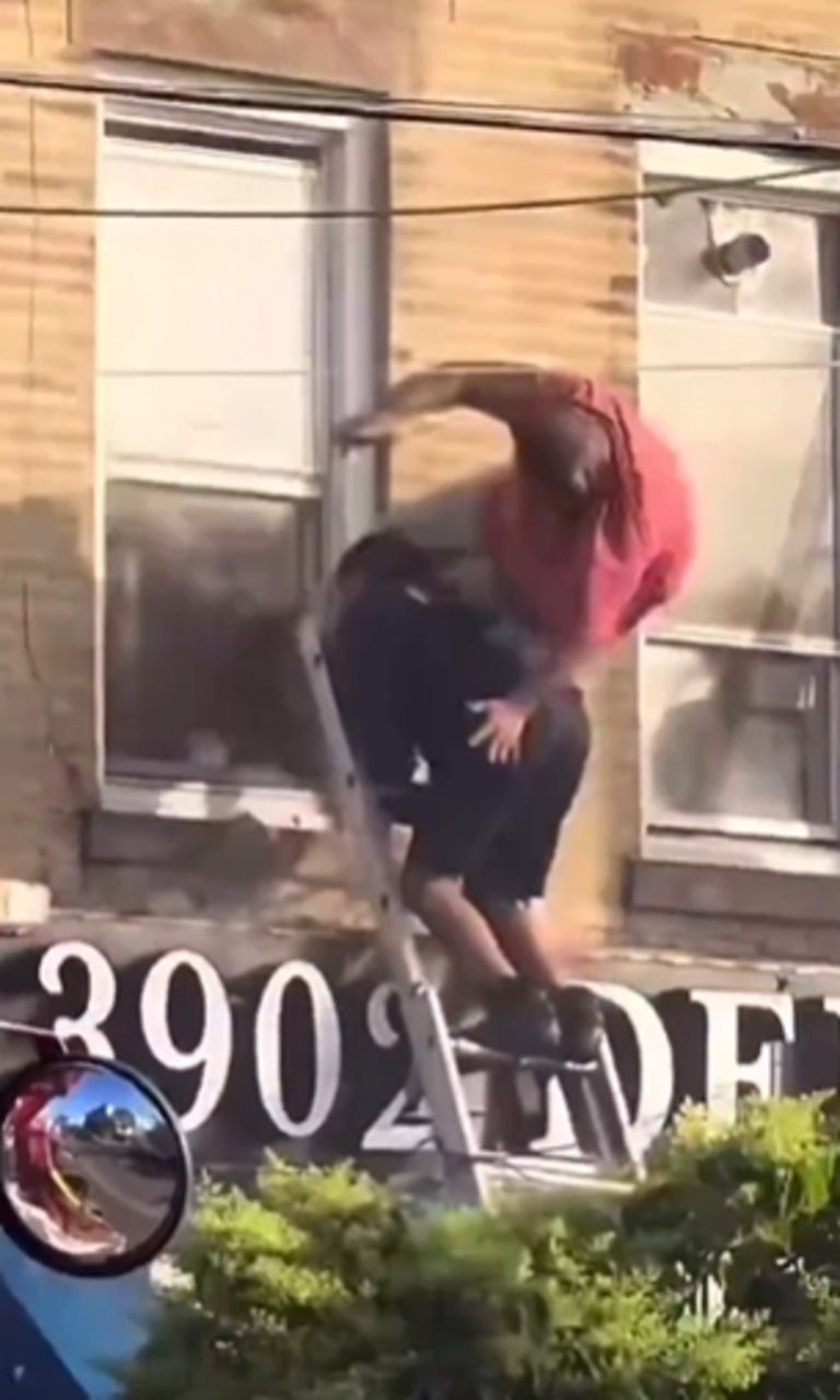 But the men fell onto the awning of a deli below before hitting the ground. Picture: X@dom_lucre