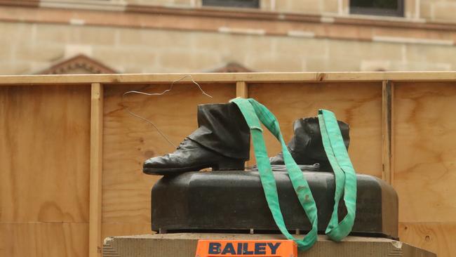 Workers from International Conservation Services begin final work of removing Crowther statue. Picture: Craig Herbert