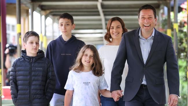 Matthew Guy arrives at Serpell Primary School to cast his ballot alongside wife Renae and his sons, Sam, Joseph and Alexander. Picture: David Caird